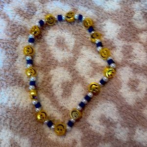 Blue Pearl necklace w/ smiley face charms on it